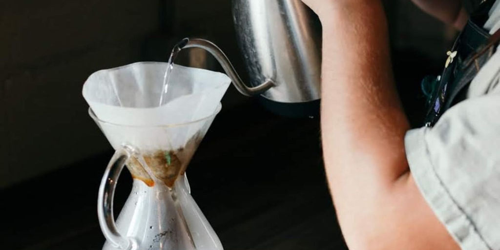 barista using the proper brewing temperature for coffee
