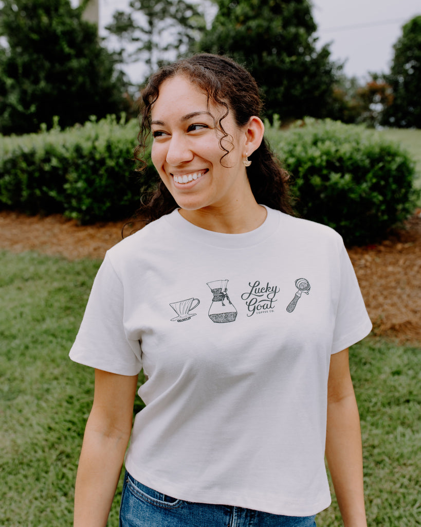 Woman wearing a white t-shirt with graphics and text outdoors