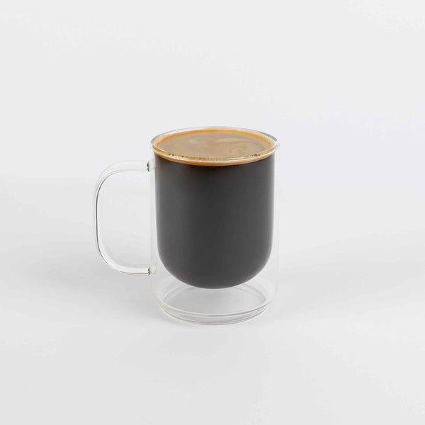 Brewed coffee in a glass mug on a white background